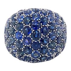 This striking big blue bombé bauble, dating back to the 1970's, features a large glittering dome composed of 95 pavé-set brilliant-cut sapphires totalling approximate 9.50 carats. The coning, high polished ring shank is finished with "a jour" worked floral motif inside the ring. Very nice workmanship. Size: 52.5 EU / 6 1/3 US Maker's mark: CLEOPATRA Italian hallmarks Dome Rings, 45th Wedding Anniversary, Dome Ring, Casting Jewelry, September Birthstone, Domed Ring, Big Blue, Precious Gemstones, Makers Mark