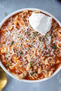 a white bowl filled with pasta and cheese