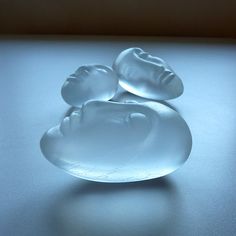 two white glass bowls sitting on top of a table