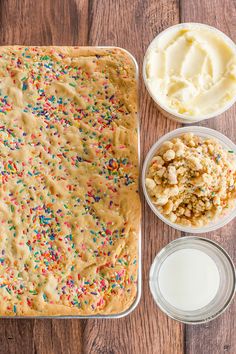 sprinkles, ice cream and cake mix in bowls on a wooden table