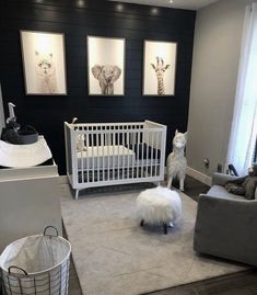 a baby's room is decorated in black, white and grey with animals on the wall