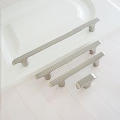 three handles on the side of a bath tub