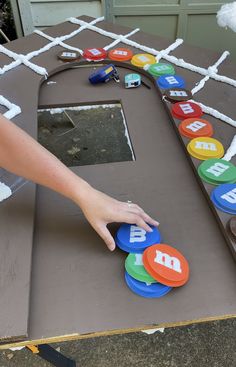 a child's hand reaching for the letter b on top of a board game