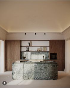 a large kitchen with marble counter tops and wooden cabinetry, along with white walls