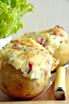 baked potatoes with cheese and vegetables on a plate