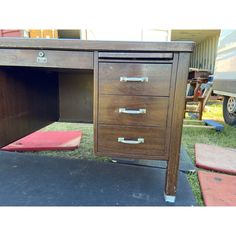 a wooden desk with drawers on top of it