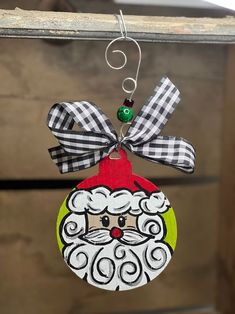 a christmas ornament hanging from a door with a santa clause face on it