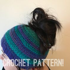 a woman with her hair in a messy bun crochet hat