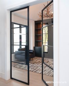 an open glass door leading to a living room