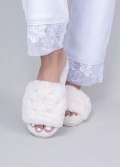 Luxe fuzzy, no-slip rubber sole slippers featuring pearl embellishments. Pair with our Jammies or Robes. Your purchase contributes to Robed With Love's commitment to donate 5% of proceeds to charities that benefit women. Click here for more information on ways we are giving back. Product Details: Fabric Content- 100% Polyester Pearl detail No-slip rubber sole Available in sizes: 6/7 and 8/9 Spot clean Pearl Slippers, Bridal Slippers, Gifts For Bride, Bride Slippers, From Miss To Mrs, Wedding Gifts For Bride, Clothing Gifts, Pearl Bridal, Bridesmaid Outfit