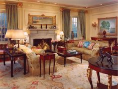 a living room filled with lots of furniture next to a fire place in a fireplace