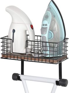 the ironing board is holding an iron and a dryer on it's stand