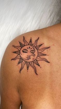 a woman with a sun tattoo on her shoulder