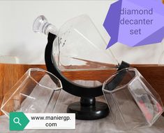 a diamond decanter set on top of a table next to an empty container