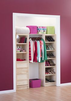 an open closet with shoes and other items on shelves in front of a purple wall