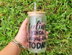 a hand holding a tumbler with the words feeling kinda nice as today on it