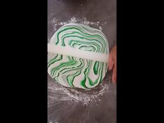 a green and white swirl cake being made