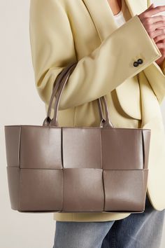 Bottega Veneta's 'Arco' tote is an ideal everyday companion thanks to its spacious interior and timeless design. It's artfully made from leather in a scaled-up version of the label's classic intrecciato weave and has a detachable zipped pouch to keep smaller items safe and organized. Luxury Taupe Leather Bag, Luxury Woven Leather Rectangular Bag, Luxury Rectangular Woven Leather Bag, Luxury Taupe Leather Shoulder Bag, Business Intrecciato Weave Tote Shoulder Bag, Elegant Beige Woven Leather Bags, Business Tote Shoulder Bag With Intrecciato Weave, Business Intrecciato Tote Shoulder Bag, Square Leather Bag With Intrecciato Weave