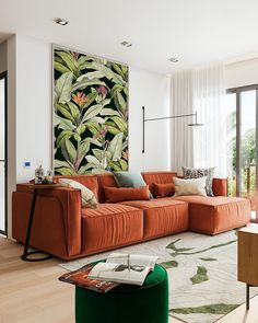 a living room with an orange couch and green chair in front of a painting on the wall