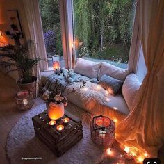 a living room filled with lots of furniture and candles