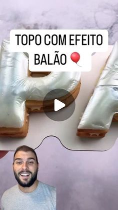 a man is standing in front of some doughnuts that are shaped like letters