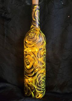 a bottle that is sitting on a black surface with some lights in the top and bottom