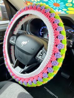 the steering wheel cover is crocheted with multicolored yarn