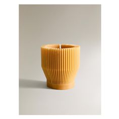 a yellow vase sitting on top of a white table