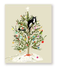 a black and white cat climbing up the top of a christmas tree with ornaments on it