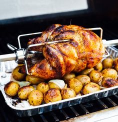 a roasting pan filled with roasted potatoes and chicken