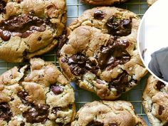 a man is smiling next to some chocolate chip cookies