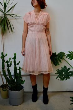 "Fifties Pink Party Dress. Textured Overlay. Wing Collar. Midriff Yoke Waistline. Metal Zipper Closure Up Side. Shoulder Pads. Lined. No Content Label, Feels Synthetic Good Vintage Condition - General Wear. Discolouration and Stains Around Hem. Seam Rip Above Zipper. Faint Armpit Stains. Some Rips In Overlay. Fits Size Small Chest - 36\" Waist - 28\" Hip - 40\" Shoulder to Hem - 42.5\" All Sales Are Final. We have taken the time to note all size measurements and the condition of each piece so pl Vintage V-neck Party Dress, Vintage V-neck Dresses For Vintage Events, Vintage V-neck Dress For Vintage Events, Retro Vintage Dress For Spring Events, 1950s Style Short Sleeve Party Dresses, 1950s Style Lined Party Dress, Retro Fit And Flare Party Dress, Summer Short Sleeve Dresses For Vintage Events, Vintage Fit And Flare V-neck Dress