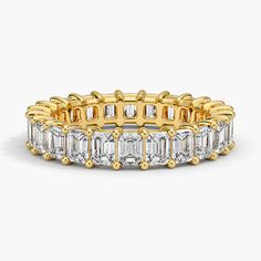 a yellow gold ring with baguetts and diamonds