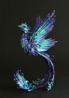 a purple and blue bird figurine sitting on top of a black surface with the words, se liberer du passe renatre la joie