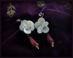 Vintage Hand Painted Bone China White Violet Flower Earrings with Crystal Drops & 14K Gold Filled Ear Wires - English Porcelain Lovely Vintage Hand Painted Bone China Porcelain Violet Flower & Crystal Earrings.  The delicate earrings are adorned with pretty violet flower,  along with a purple crystal bead drop. The earrings measures approximately 2 inches long by 5/8 inches, at the widest and has 14K gold filled ear wires. Really gorgeous pair of assemblage earrings. Beautiful for wedding jewelry. The matching brooch shown in photos is sold separate, please check our listings if you desire the set. See more of GradyLadies Jewelry here: https://www.etsy.com/shop/gradyladies?section_id=12904086 Assemblage Earrings, White Violet, Flower Crystal, Violet Flower, Purple Crystal, Purple Crystals, Gorgeous Bracelet, Delicate Earrings, Crystal Drop