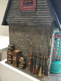 a model house with brooms and other items on display