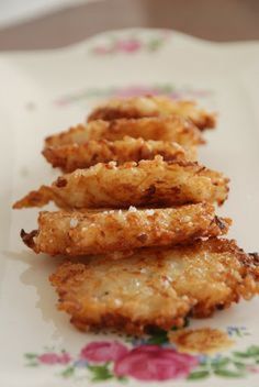 some fried food is sitting on a flowered plate and ready to be eaten by someone