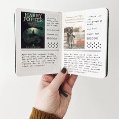 a hand holding an open harry potter book