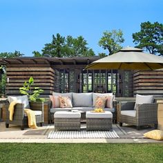 an outdoor living area with patio furniture and umbrella