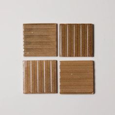 four pieces of brown paper sitting on top of each other