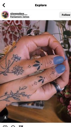 two hands with tattoos on their fingers