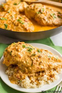 chicken with gravy and rice in a skillet on a green tablecloth