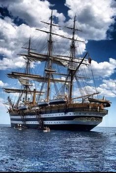 an old sailing ship in the middle of the ocean