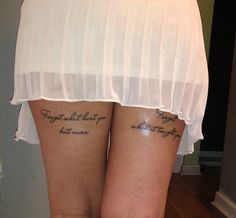 two women with matching tattoos on their butts, both have words written on them