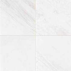 a white tile wall with four squares in the middle and one square at the top