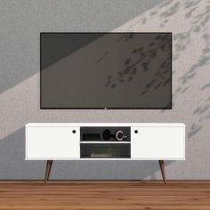 a flat screen tv sitting on top of a white entertainment center next to a wooden floor