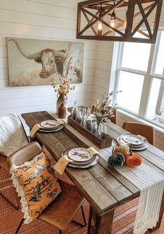 a dining room table with plates and place settings