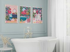 a bathroom with two pictures on the wall and a bathtub in the foreground