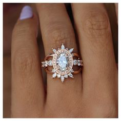 a woman's hand with an engagement ring and diamond set on top of it