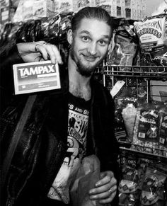 a man standing in front of a shelf filled with food